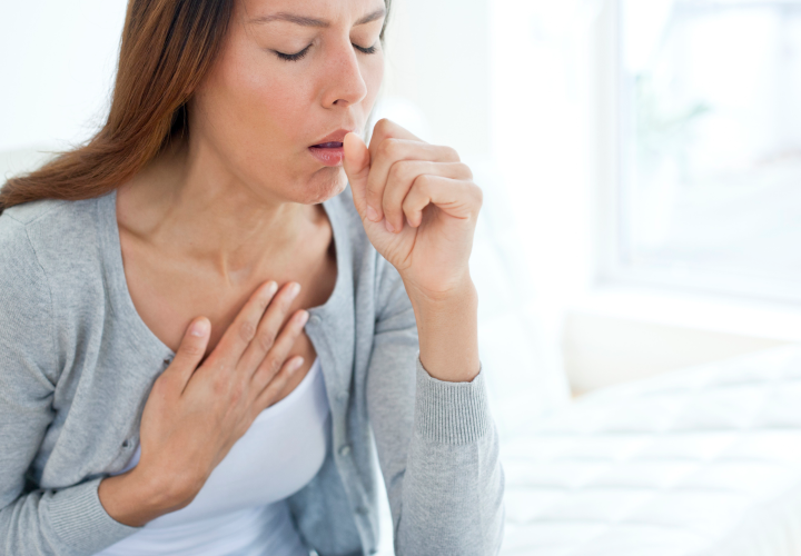 Image of woman experiencing asthma symptoms